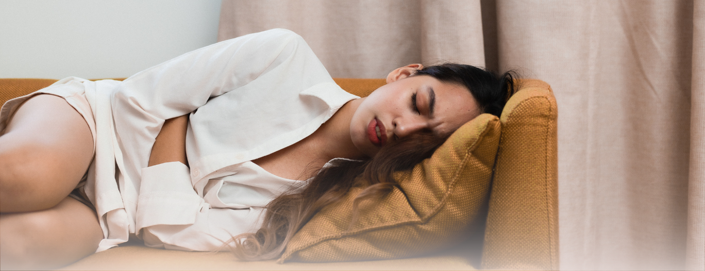 woman in pain on couch